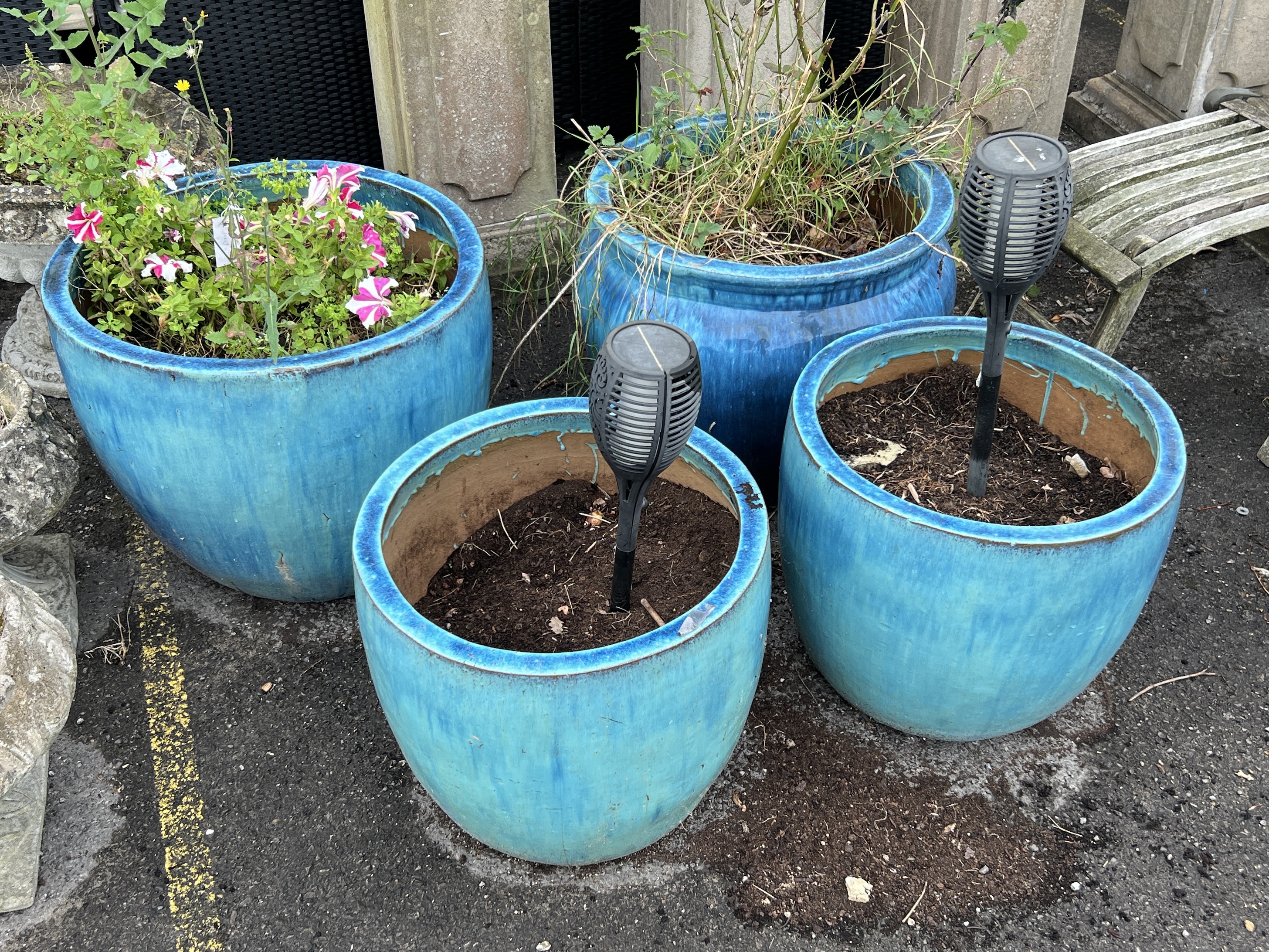 Four large blue glazed circular earthenware garden planters, largest diameter 59cm, height 49cm
